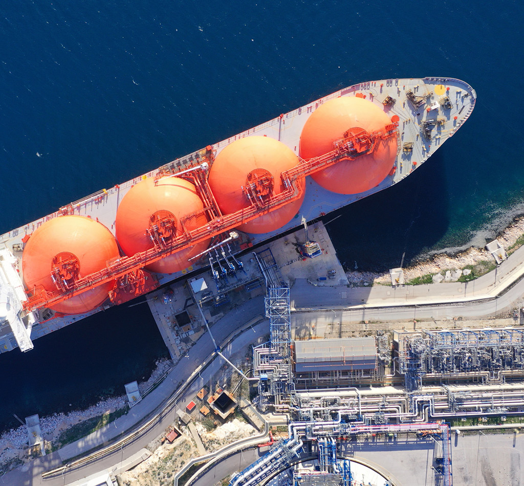 Top down view of LNG (Liquified Natural Gas) tanker anchored in small gas terminal island.